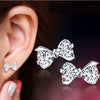 POLISHED FANTASY - SILVER BOW STUD EARRINGS
